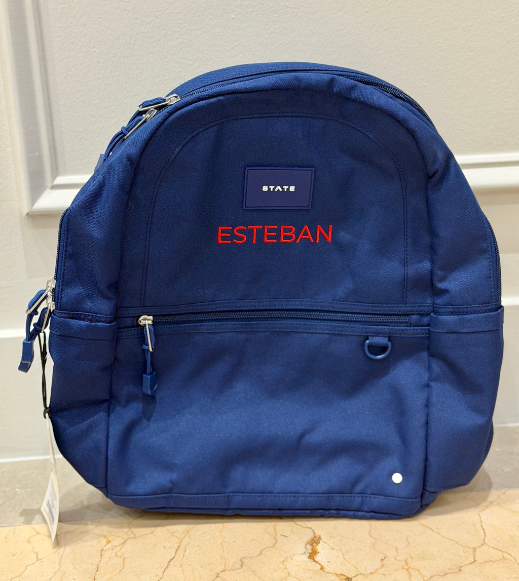 Navy kids backpack with the name Esteban custom embroidered in red block letters