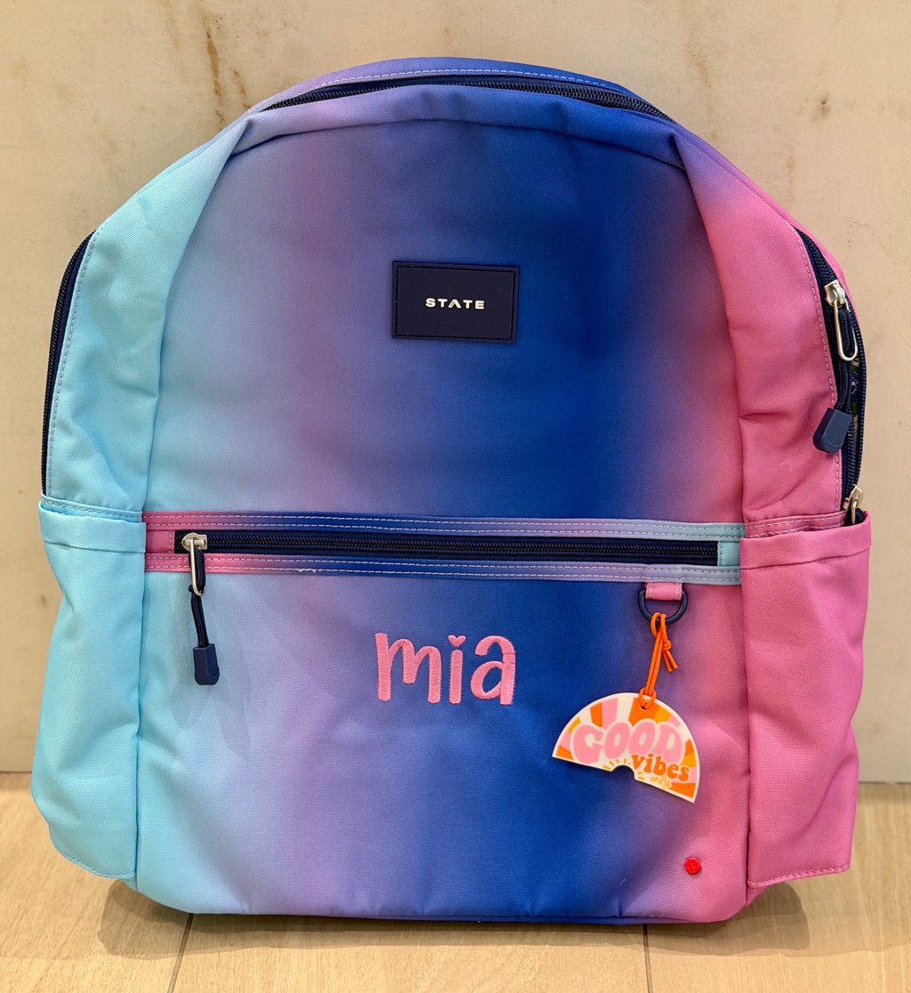 Blue and pink ombre backpack custom embroidered with the name Mia in pink letters with a heart