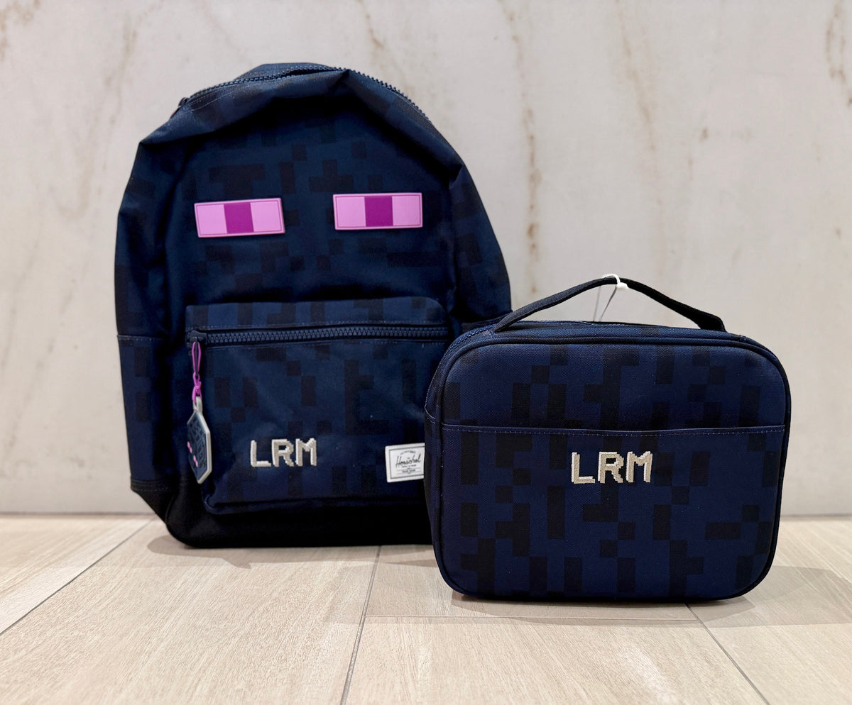 Navy pixel print backpack and lunch box set custom embroidered with the monogram LRM in silver pixel letters