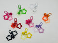Jingle Star charms with two open stars and a jingle bell in nine colors with matching swivel clasps