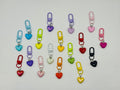 Puffy Heart charms in seventeen solid and pearlescent colors with coordinating swivel clasps