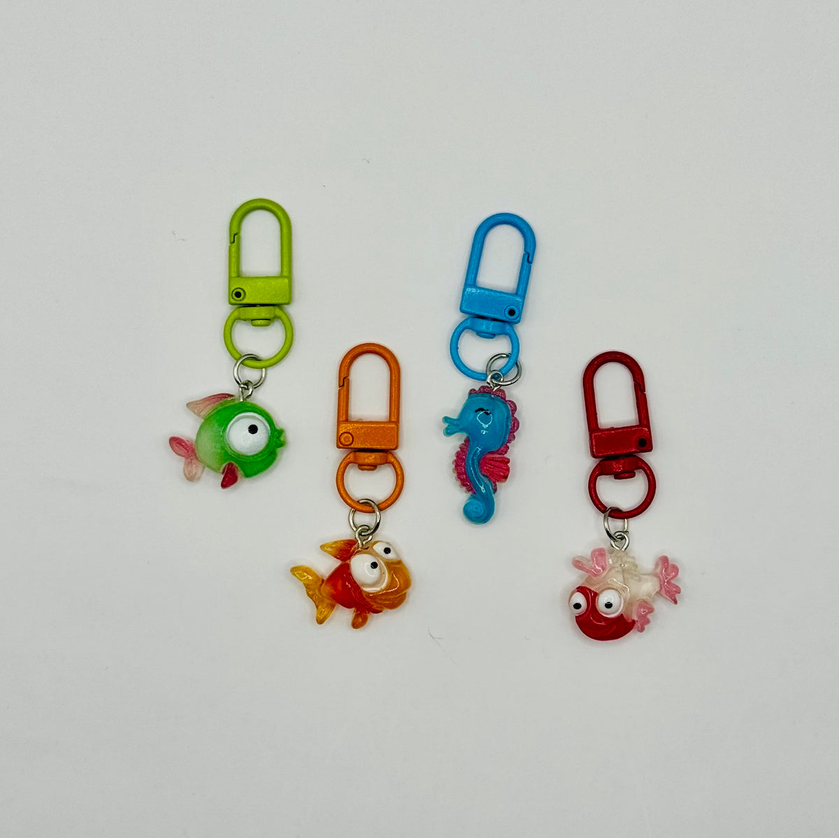 Under the Sea charms: green fish, orange fish, blue seahorse and red fish with matching swivel clasps